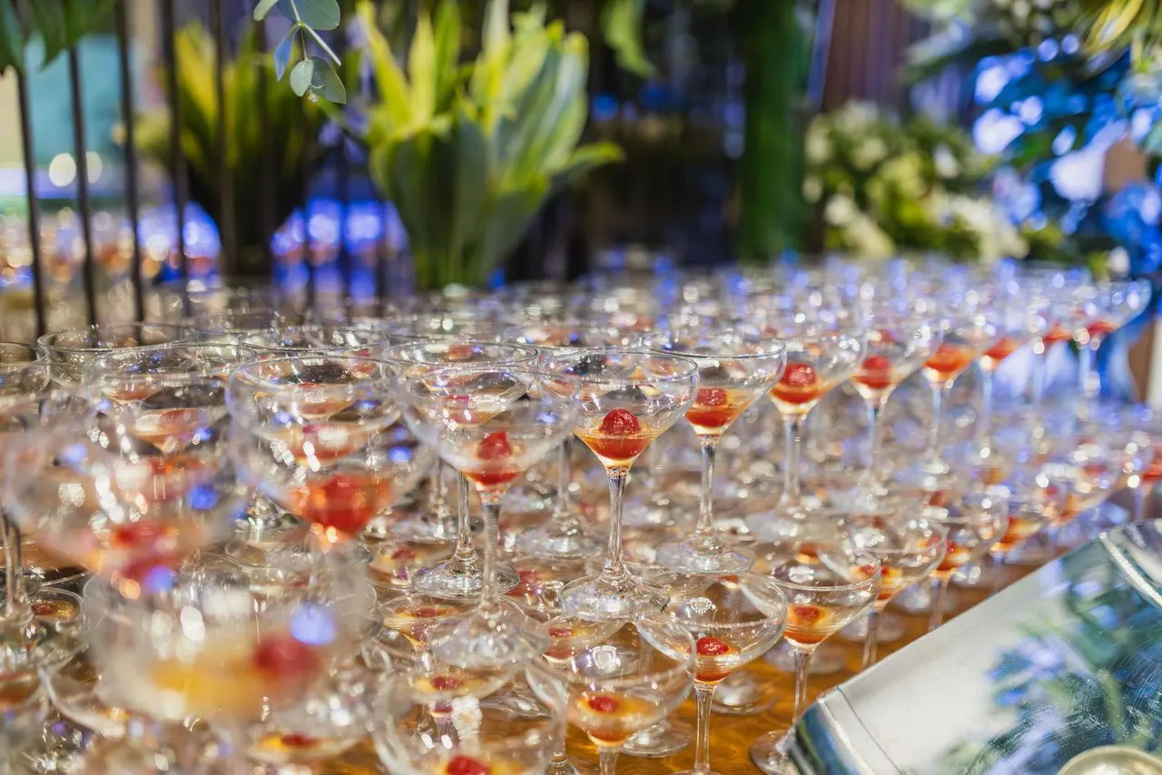 Rows of cocktail glasses with cherries